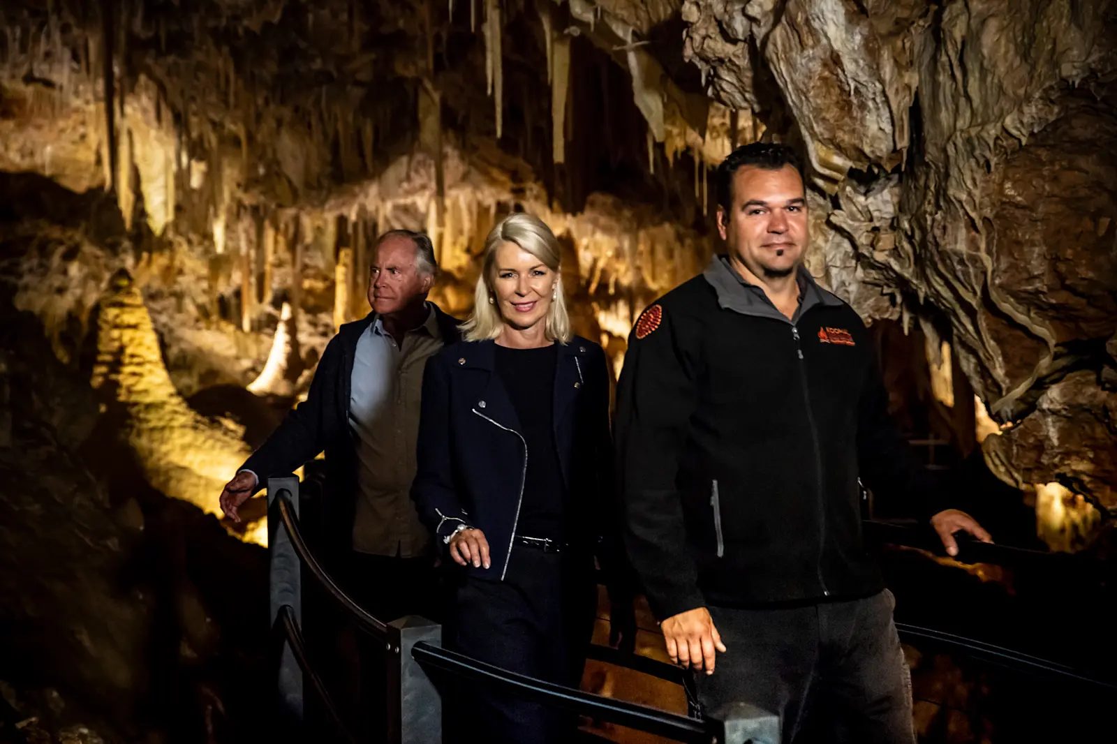 Koomal Dreaming tour guide walking with a couple in the Ngilgi Cave, Margaret River, WA © Tourism Australia 

 