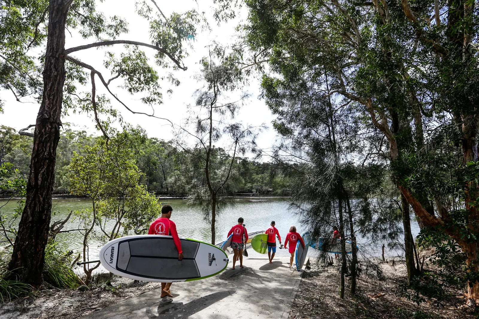 Group heading to Moonee Creek on the Coffs Coast for a stand-up paddl boarding tour with Wajaana Yaam Gumbaynggirr Adventure Tours, NSW © Destination NSW