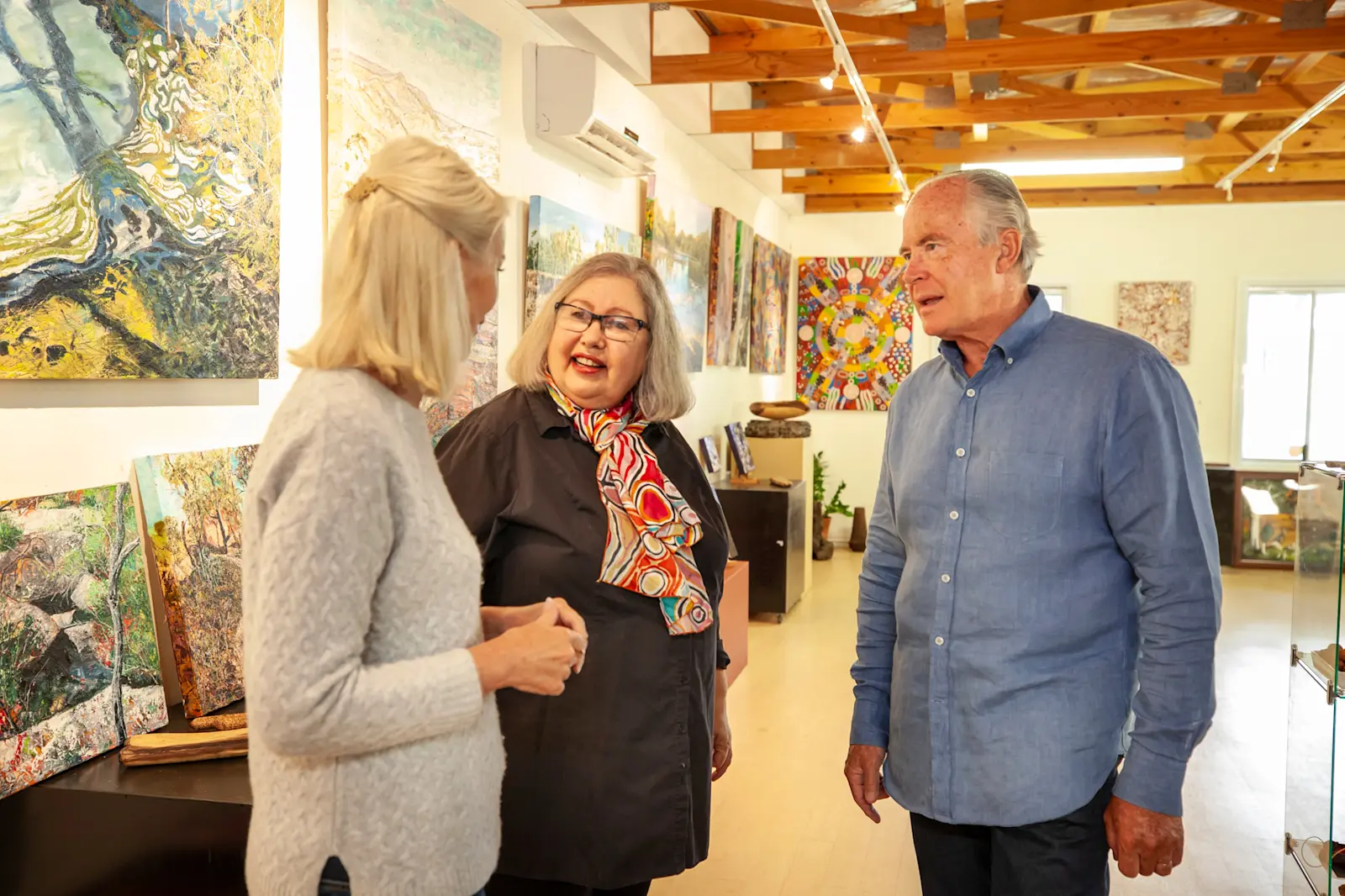 Dale Tilbrook inside art gallery with guests, WA © Tourism Australia 