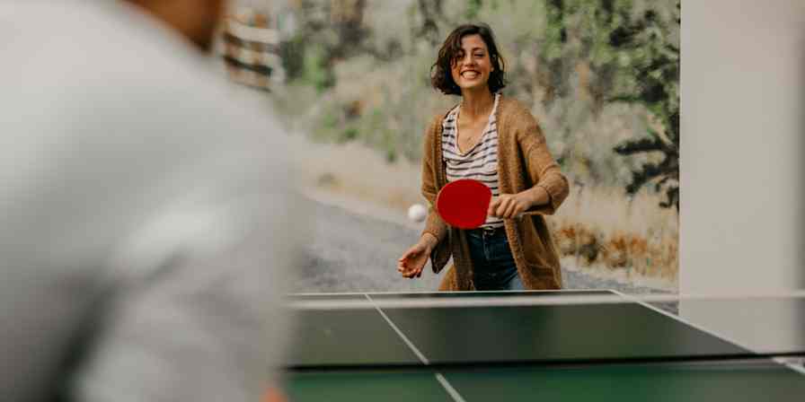 Hero image with a person playing table tennis, representing team building
