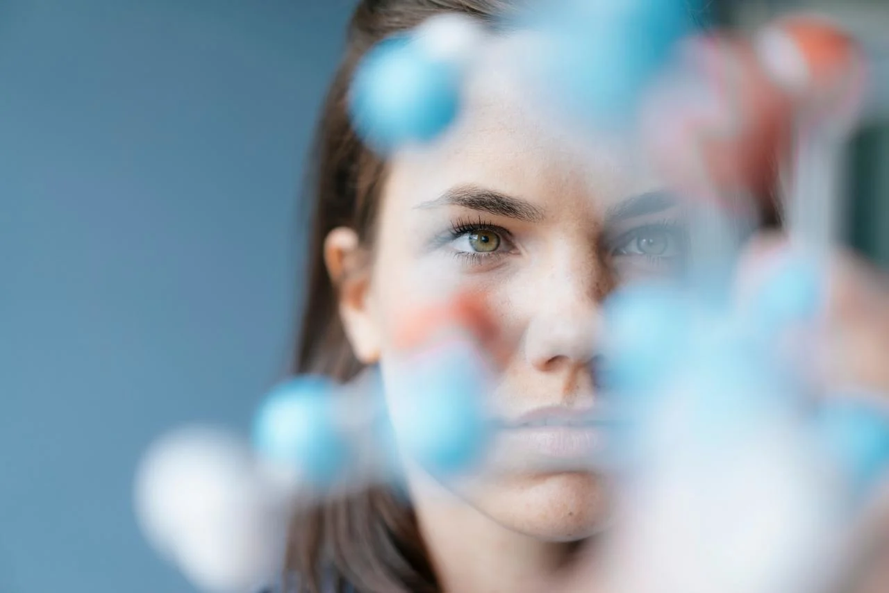 Female scientist studying molecule model, looking for solutions | Neste